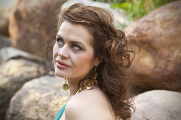 girl with flowing hair on the background of rocks