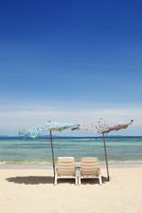 Beach Chairs and Umbrella on a beautiful island, panoramic view