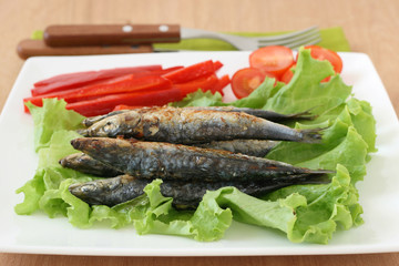 Fried sardines on lettuce