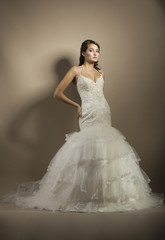 The beautiful young woman posing in a wedding dress