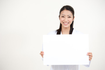 beautiful asian nurse holding a blank whiteboard