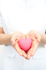 a nurse holding a symbol of heart