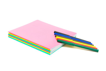 notebooks and pens on a white background