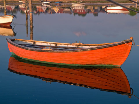 Reflection of a small dinghy dory boat