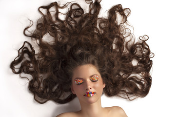 Fototapeta premium cute girl with colored makeup and curly hair