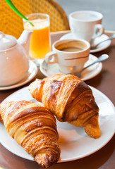 Breakfast with coffee and croissants