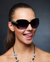 Girl with sunglasses showing her tongue