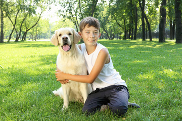Tennager boy in the park with a dog