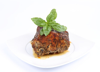 Roast pork decorated with basil