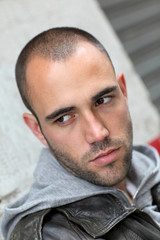 Fototapeta premium Portrait of bad boy waiting in the street