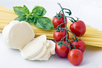 Italian food: spaghetti, mozzarella, cherry tomatoes and basil