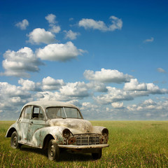 An Abandoned Old Car with Grass Landscape