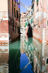 Houses reflected in the water in Venice (Italy)