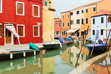 Houses and boats reflected in the water in Venice, Italy