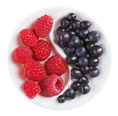 Red raspberry versus black bilberry in Yang Yin shaped plate, is