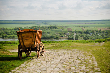 Old traditional medieval european wooden cart on the road © pmstudio