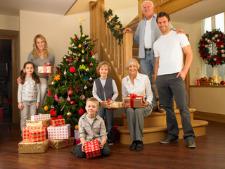 Obraz na płótnie Canvas Family with gifts around the Christmas tree