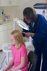 Nurse checking for head lice