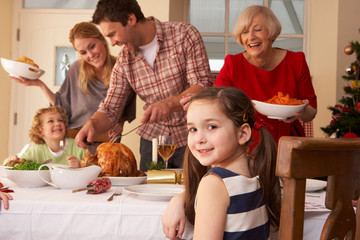 Family serving Christmas dinner