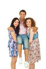 Obraz premium Two happy women carrying man