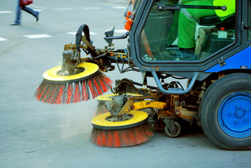 machine cleaning dust from sidewalk