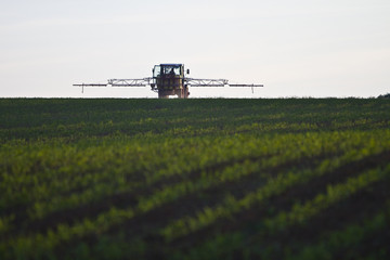 tractor with pesticide on field