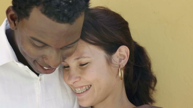 young interracial couple dating and hugging