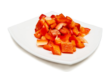 slices of red sweet paprica on white square plate