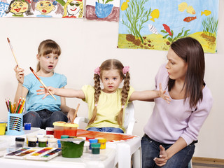 Child painting in preschool.