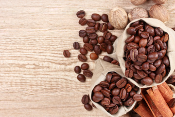 cinnamon, coffee, nutmeg and on wooden background