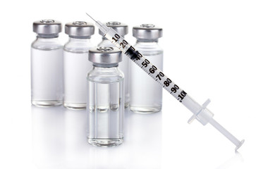 medical ampoules and syringe isolated on white