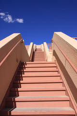 Stair case with red steps against blue sky