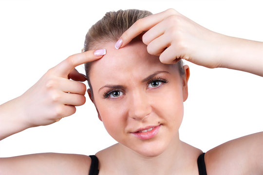 woman squeeze pimple on white background