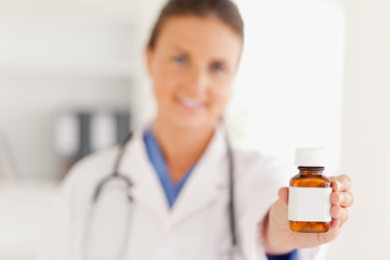 Cute doctor handing over some pills