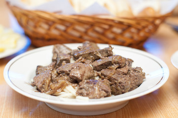 Spaghetti with liver on white background