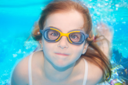 children girl funny underwater with goggles