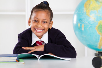 happy elementary school girl in classroom