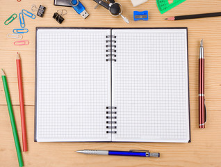 school accessories and notebook on wood