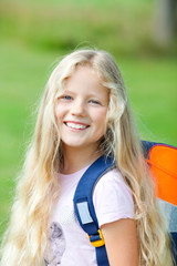 girl outdoor with school bag go to school  smiling