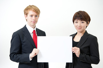 businessteam holding a blank whiteboard