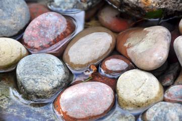 Large multicolored stones in water