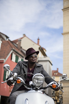 Cool Black Man Riding A Scooter