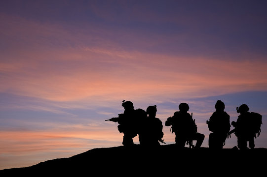 Silhouette of modern troops in Middle East silhouette
