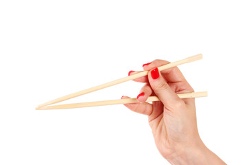 woman's hand and wooden chopsticks isolated on white