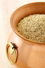 raw quinoa on copper pot