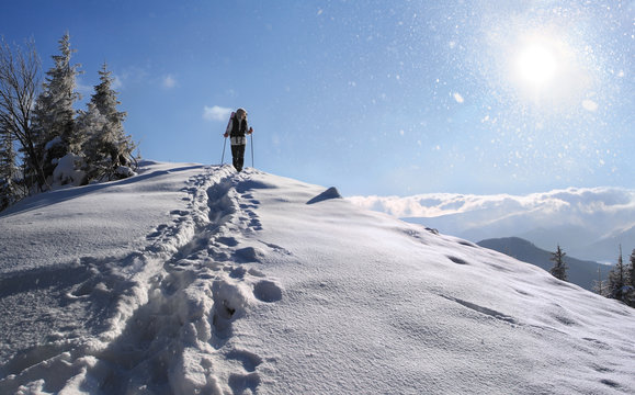 Happy girl hiking in the mountains at winter