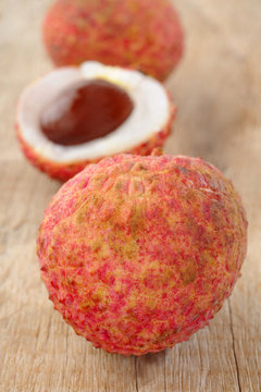 ripe lychee on wood background