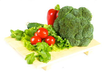 fresh and juicy vegetables on the wood plate isolated