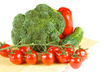 fresh and juicy vegetables on the wood plate isolated