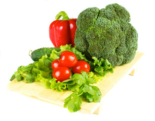 fresh and juicy vegetables on the wood plate isolated